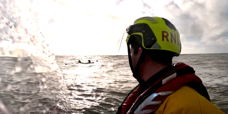 The Shoreham inshore lifeboat approaches the outriggers Lifeboat rescues four people in swamped boat